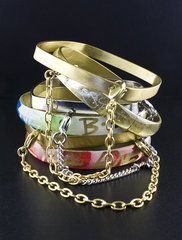 set includes enamel and metal bangles attached by a chain