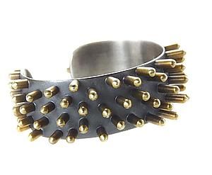 silver and brass bracelet with spikes